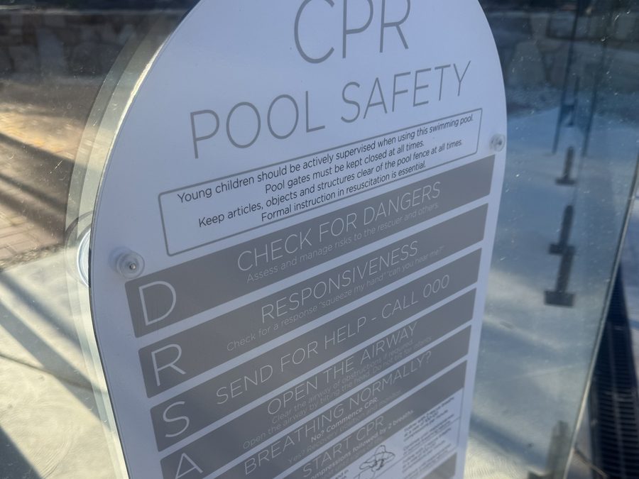 Resuscitation chart mounted on a glass pool barrier